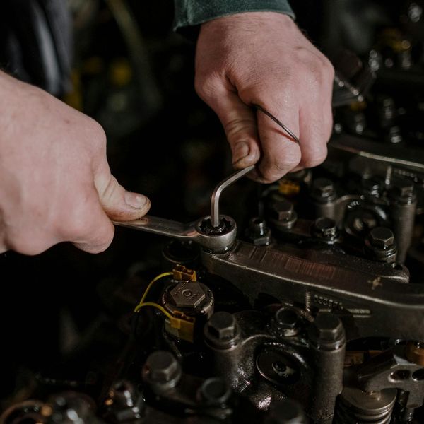 Experienced mechanic performing detailed engine inspection